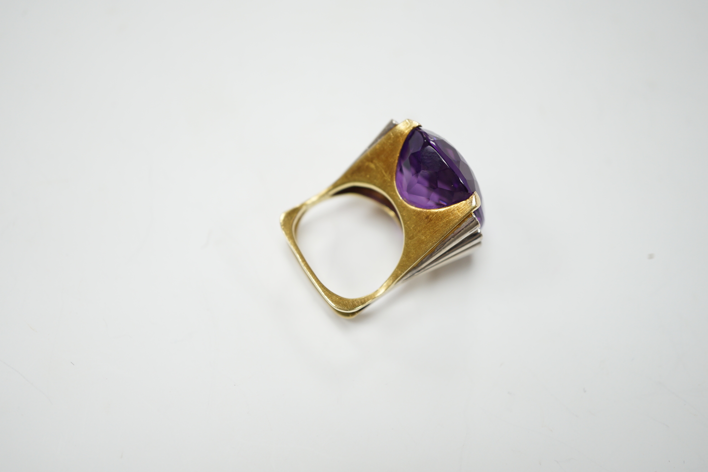 A large yellow and white metal and single stone oval cut amethyst set dress ring, flanked by eight small round cut diamonds, size K, gross weight 15.3 grams.